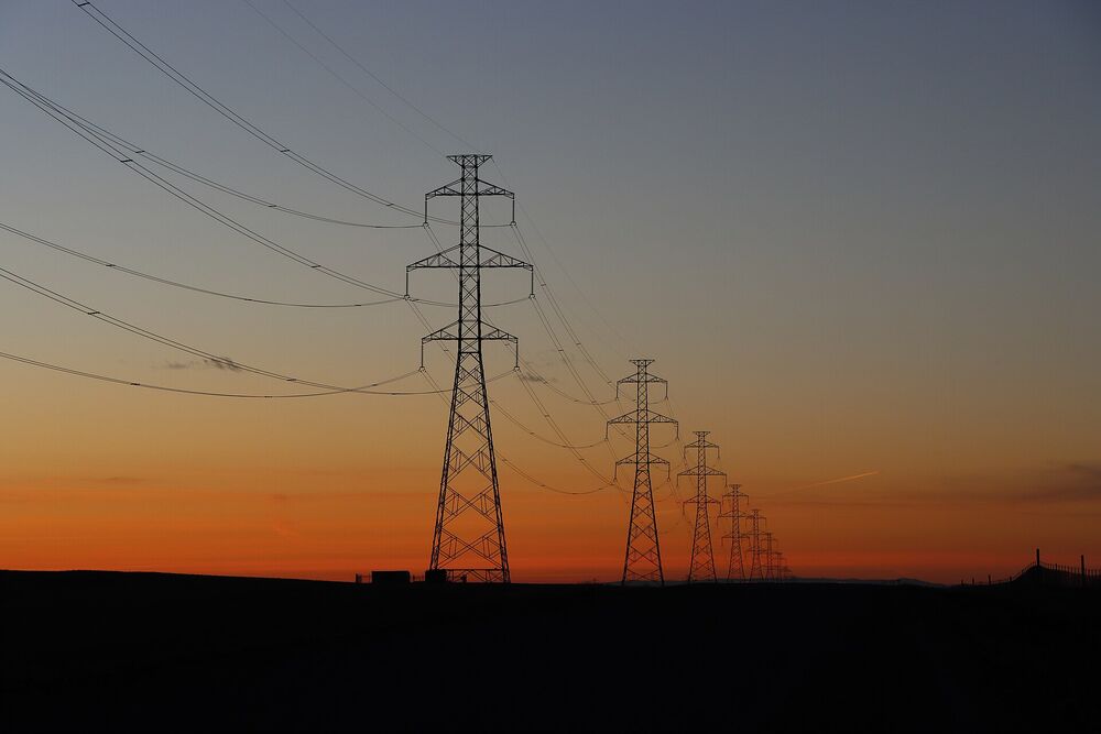 High-voltage transmission towers at sunset